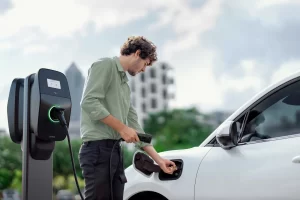 A tenant charging an electric vehicle (EV) at an EV charging station.