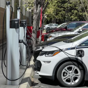 Multiple EVs charging at Level 2 EV chargers in a shared parking space.